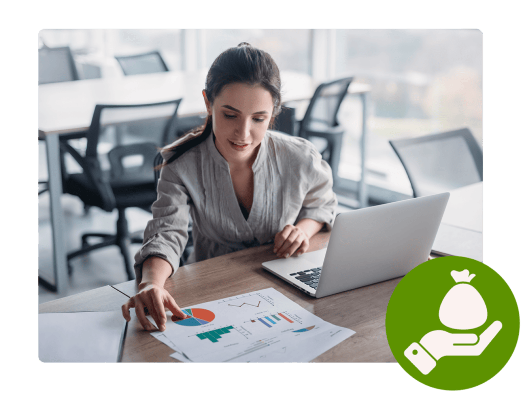 Woman with laptop and printouts with diagrams.