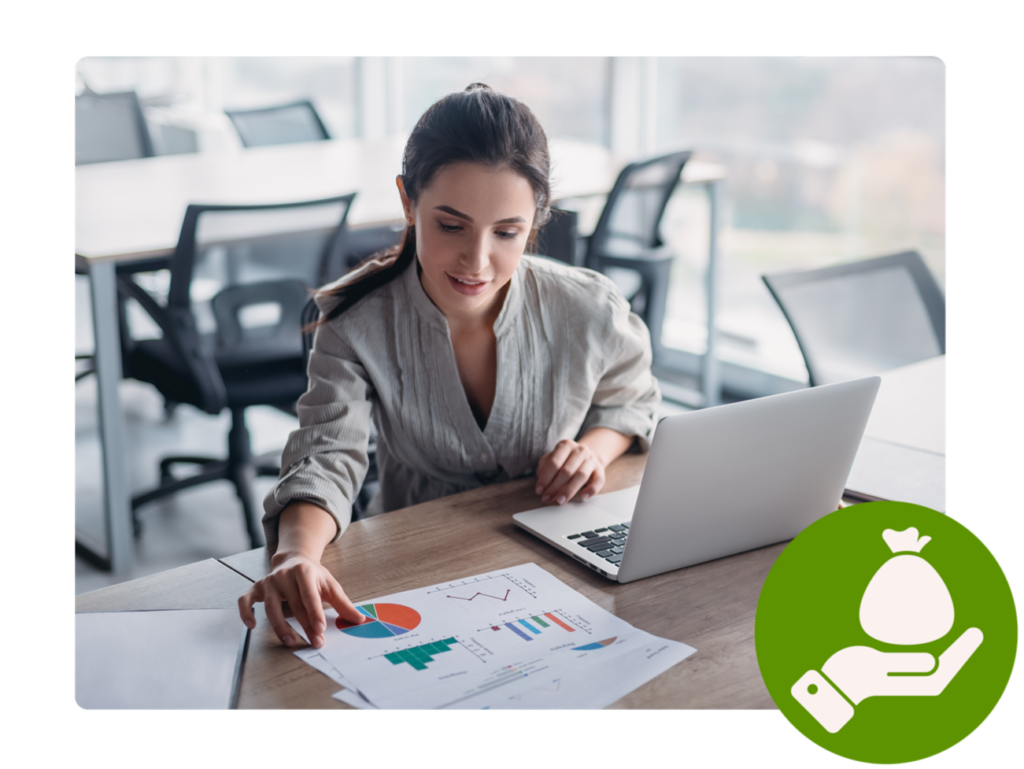 Woman with laptop and  printouts with diagrams.